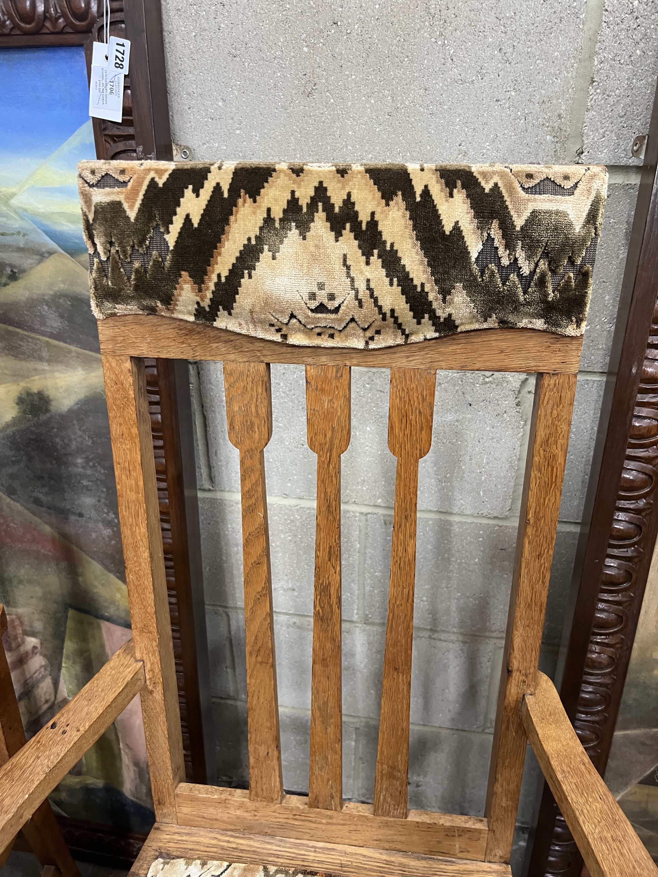 A pair of early 20th century Arts and Crafts oak elbow chairs, width 61cm, depth 55cm, height 118cm